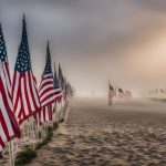 A solemn row of American flags against the misty backdrop of the Normandy D-Day Beaches, without any human presence.